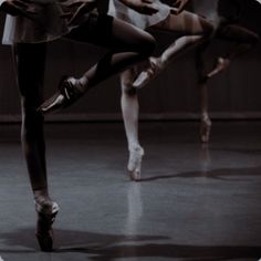 three ballerinas in white and black are dancing