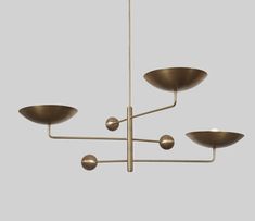 a brass chandelier with five lights hanging from the ceiling and four bowls on each side