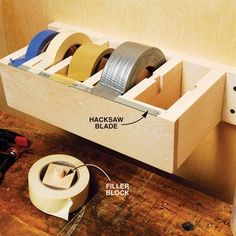 tape dispensers are stored in a drawer on the floor next to tools