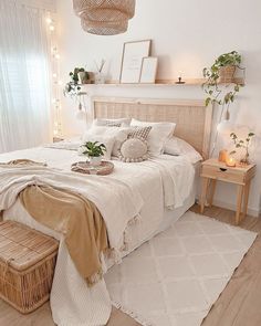 a bedroom with white walls and wooden flooring is decorated in neutral tones, including wicker furniture