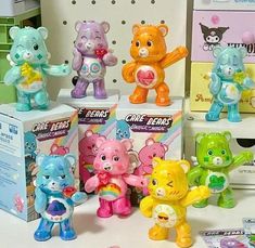 there are many different toy bears on the table with other toys in front of them