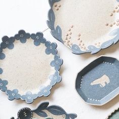 three blue and white plates with animals on them