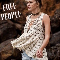 a woman wearing a crochet top with the words free people written on it