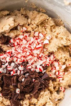 a bowl filled with chocolate and candy canes on top of it's side