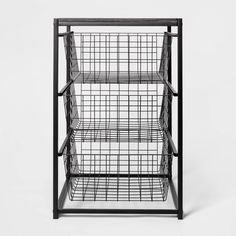 a black metal shelf with wire baskets on top