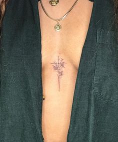 a woman with a cross tattoo on her chest