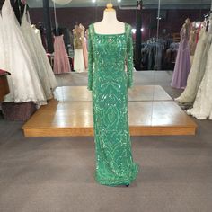 Long Mesh Sleeve With The Dress Having Full Sequin Beading Pattern, And Scoop Neck Embellished Floor-length Green Sequin Dress, Embellished Green Gown For Banquet, Embellished Green Floor-length Sequin Dress, Green Hand Embellished Evening Dress, Elegant Hand Embellished Green Gown, Elegant Green Hand-embellished Gown, Embellished Green Floor-length Evening Dress, Green Embellished Sequin Dress For Evening, Green Embellished Floor-length Evening Dress