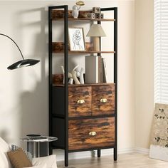 a living room with a bookcase and a lamp on the side table in front of it