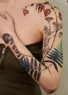 a woman with tattoos on her arm and shoulder