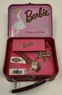 a pink tin with some items inside of it