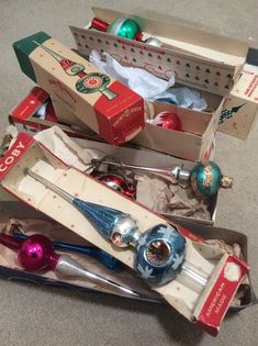 several christmas ornaments are in boxes on the floor next to each other and one is empty