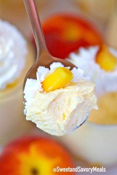 a spoon with some dessert on it and an apple in the back ground next to another bowl