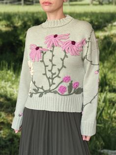 Life is too short to wear boring clothing! This unique embroidered sweater is a one-of-a-kind piece that will truly make you stand out from the crowd. Handcrafted from the highest quality Italian merino yarn, the extremely cosy crewneck features a loose fit and cute 3D decoration in floral motives to create an eye-catching look. DETAILS -Relaxed fit. -Crewneck. -Long sleeve. -Hand-knitted and hand-embroidered. -       Unique, one-of-akind -       Colour: light green Designed and ethically made i Fitted Cotton Sweater With Floral Embroidery, Spring Sweater With Multicolor Embroidery And Long Sleeve, Multicolor Embroidered Long Sleeve Spring Sweater, Fitted Long Sleeve Sweater With Floral Embroidery, Fall Sweater With Multicolor Embroidery And Long Sleeves, Fitted Crew Neck Sweater With Floral Embroidery, Fall Long Sleeve Sweater With Multicolor Embroidery, Long Sleeve Sweater With Multicolor Embroidery For Fall, Fall Floral Embroidered Crew Neck Sweater