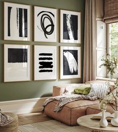 a living room filled with furniture and pictures on the wall above it's coffee table