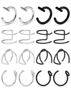 several different types of metal ear rings on a white background with the letters c, e, and f