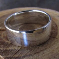 This ring makes a great man's wedding band, as it is low-profile and durable. It is made of argentium sterling silver, so it has a higher silver content than regular sterling and is age-hardened (heated in my kiln to make the ring almost as hard as gold). It is 8mm wide and 1mm thick.The band is comfort-fitted (convex shape on the inside) making it super comfortable and is casted, so there is no solder joint.The same ring is available in a brush-finish here:https://www.etsy.com/listing/150551875 Classic Sterling Silver Wide Band Promise Ring, Classic Silver Engraved Wide Band Ring, Classic Thick Band Ring In Sterling Silver, Classic Wide Band Ring In Sterling Silver, Silver Engraved Ring With Polished Finish And Thick Band, Sterling Silver Thick Band With Polished Finish, Sterling Silver Wide Band With Polished Finish, Wide Band Sterling Silver With Polished Finish, Classic Silver Wide Band Ring With Polished Finish