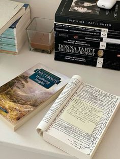 three books sitting on top of a table next to an earbud headphones