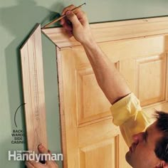 a man is working on an unfinished door