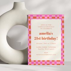 a pink and orange birthday card next to a white vase