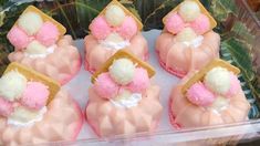 some pink and white desserts in a plastic container