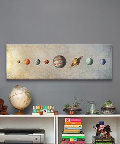 a painting on the wall above a bookshelf filled with books and other items