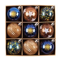 six christmas ornaments in a box on a white background