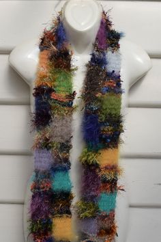 a multicolored scarf hanging on a white mannequin