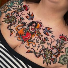 a woman's chest with tattoos on it