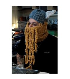 a man wearing a knitted hat with dreadlocks