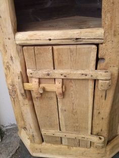 an old wooden cabinet with two doors on the front and one door open to reveal it's contents