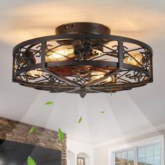 a ceiling light that is hanging from the ceiling in a room with white walls and green leaves