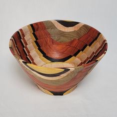 a wooden bowl sitting on top of a white table