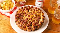 a heart shaped pizza on a plate with chips and beer