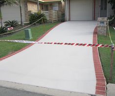 a house with a red and white ribbon on the driveway