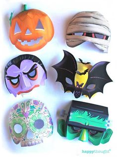 halloween masks are arranged on a white surface