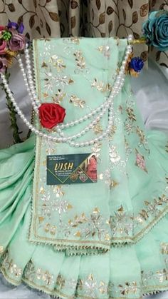 a dress with pearls and flowers on it