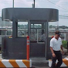 a man walking down the street in front of a bus stop that is closed to traffic