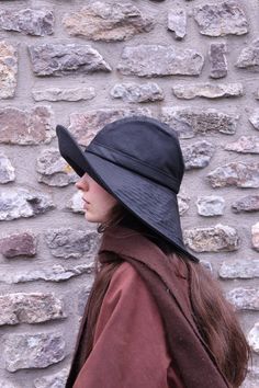 "The 'Storm Chaser' is based on the traditional form of collapsible Waxed Cotton Sou'westa rain hat that is longer in the back than the front to protect the neck fully. The hat has a roll up brim at the front which works like a gutter whilst keeping the face clear. The brim extends down the back, bridging and protecting the neck.  The 'Storm Chaser' is the perfect choice for women who have to be out in the worst weather but want to be looking their best.  Because the brim is large there are adde Winter Sun Hat, Rain Hats For Women, Solid Wide Brim Waterproof Bucket Hat, Adjustable Waterproof Brimmed Hats, Wide Brim Weatherproof Hat For Outdoor, Waterproof Solid Color Wide Brim Sun Hat, Weatherproof Curved Brim Hat For Travel, Black Waterproof Hat With Curved Brim, Waterproof Wide Brim Sun Hat