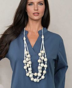 Embrace the layered elegance of this soft white wood necklace, featuring multi-strand beads woven together to create a playful layered effect. The adjustable length ensures a perfect fit for any neckline, making it a versatile addition to your jewelry collection.Design Feature: Multi-strand beads in varying sizes for a layered effectMaterial: Made of wood for a lightweight and comfortable wearSize: The necklace length adjusts from about 29” to 39” in length. Beads vary from 8mm to 20mmCountry of Wood Bead Necklace, Ethnic Necklaces, Wood Necklace, White Beads, Multi Strand, Unique Necklaces, Bead Weaving, Wood Beads, Gemstone Necklace