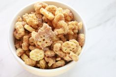 a white bowl filled with cereal on top of a table