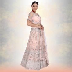 Introducing the Mirror Work Lehenga Choli - a stunning piece of Indian couture that is perfect for special occasions and family weddings. This beautiful lehenga choli is made with pure net fabric, and is adorned with heavy mirror work that shimmers and glitters in the evening light. The matching dupatta adds an extra touch of elegance to this outfit, making it perfect for making a grand entrance at any event. Whether you're attending a party, wedding or festive celebration, this lehenga choli is Anarkali Style Floor-length Wedding Lehenga, Wedding Anarkali Lehenga, Floor-length Lehenga With Sheer Dupatta, Wedding Floor-length Choli With Resham Embroidery, Wedding Resham Embroidery Floor-length Choli, Organza Lehenga With Zari Work For Wedding, Wedding Lehenga With Zari Work In Organza, Floor-length Lehenga For Reception, Floor-length Choli With Sheer Dupatta For Wedding