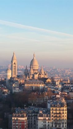 the city skyline is seen from above in this view looking down on some buildings and spires