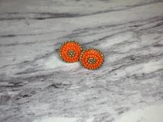 Handmade Beaded earrings. Iridescent orange and opaque gold glass seed beads size 11/0 sewn on stiffened felt, attached with faux red suede with a gold plated post.  Small size, they're less than 7/8 of an inch.  Made with the intention of raising awareness of Orange Shirt Day. $5 of this purchase will be donated to orangeshirtsociety.org to help raise awareness about the history of Residental schools in Canada. Every Child Matters! Care Instructions: Do not get wet, remove before showering or s Orange Earrings With Gold Beads As A Gift, Orange Earrings With Gold Beads For Gift, Orange Beaded Round Earrings, Orange Beaded Earrings With Gold Round Beads, Orange Earrings With Tiny Round Beads, Adjustable Orange Tiny Beads Earrings, Orange Shirt Day, Handmade Beaded Earrings, Every Child Matters