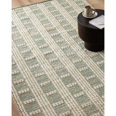 the rug is made from woven fabric and has an interesting pattern on it, as well as