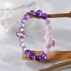 This extraordinary piece combines the transformative energies of amethyst, lepidolite, and Herkimer diamond to create a powerful synergy that promotes spiritual growth, balance, and protection. • Spiritual Transformation: Amethyst enhances spiritual awareness, intuition, and psychic abilities, while lepidolite supports emotional healing and balance. • Protective Energy: The bracelet serves as a shield of spiritual light, purifying and protecting your energy field from negative influences. • Synergistic Energy: The combination of amethyst, lepidolite, and Herkimer diamond creates a powerful synergy that supports spiritual growth, balance, and clarity. Bead Diameter: 7.5 mm, 9.5 mm Length: 17 cm Material: Amethyst, Lepidolite & Herkimer Diamond Amethyst Crystal Bracelet As Spiritual Gift, Amethyst Crystal Bracelet For Spiritual Gift, Spiritual Amethyst Crystal Bracelet As Gift, Spiritual Rose Quartz Crystals With Natural Stones, Spiritual Rose Quartz Crystals, Pink Amethyst Spiritual Jewelry, Pink Amethyst Healing Bracelets, Rose Quartz Gemstone Bracelet For Meditation, Pink Amethyst Healing Bracelet