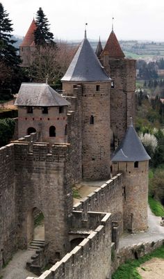 an old castle with two towers and stairs