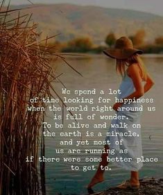 a woman standing next to a body of water with a hat on her head and the words, we spend a lot of time looking for happiness when the world right around us is full of wonder