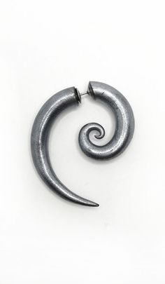 a metal spiral shaped object on a white surface