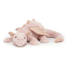 a pink stuffed animal laying on the ground