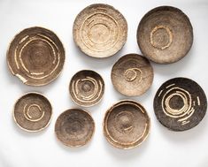 several bowls with designs on them sitting next to each other in front of a white background